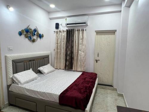 a bedroom with a bed and a window and a door at Atlas Homes 1BHK HomeStays in Hyderabad