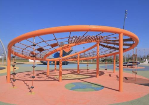 a playground with an orange metal structure in a park at Ocean Park Zenata City Eco in Casablanca