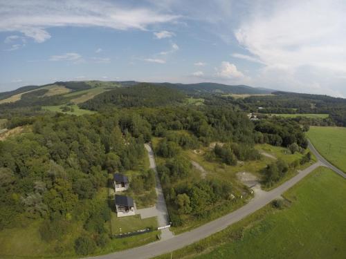 an aerial view of a house and a road at Przylesie Domki in Wysoczany