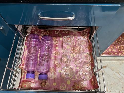 a box of wine glasses sitting on a table at Atlas Homes 1BHK HomeStays in Hyderabad