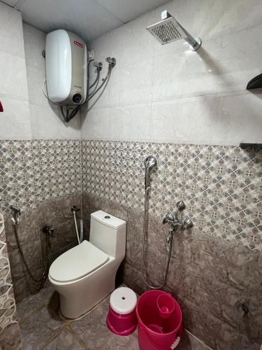 a bathroom with a toilet and a shower at Atlas Homes 1BHK HomeStays in Hyderabad