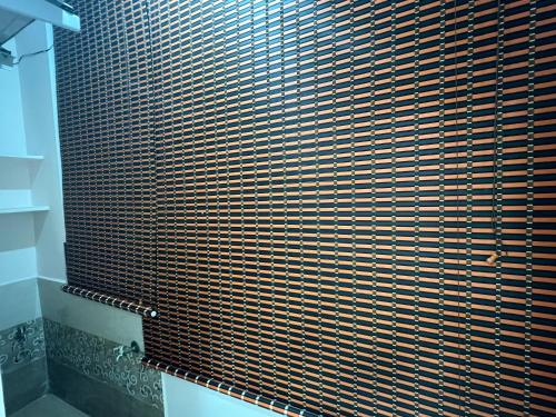 a shower with a brown and white patterned shower curtain at Atlas Homes 1BHK HomeStays in Hyderabad