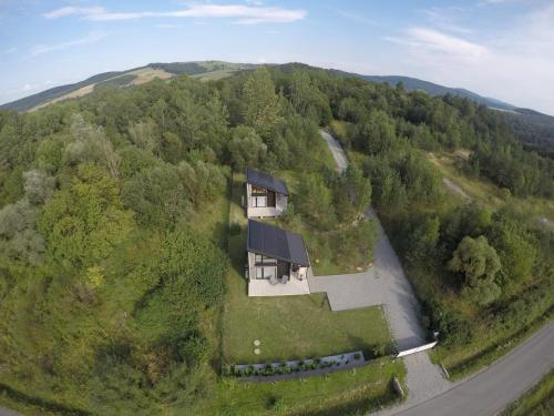 an aerial view of a house in the middle of a forest at Przylesie Domki in Wysoczany