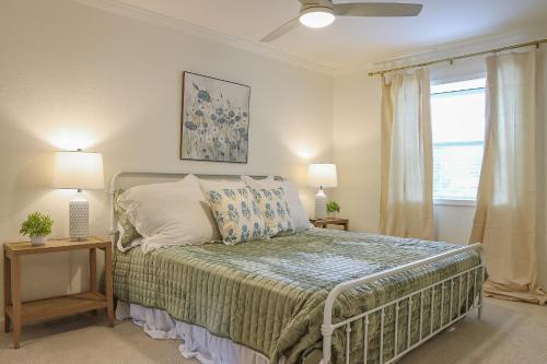 a bedroom with a bed with two lamps and a window at Oxford Condo in Oxford