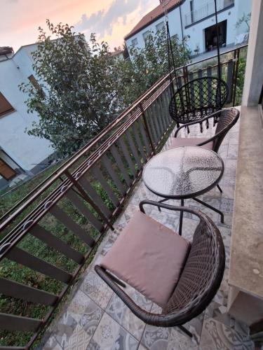 a patio with a table and chairs on a balcony at apartma-sobe Lejla in Vipava