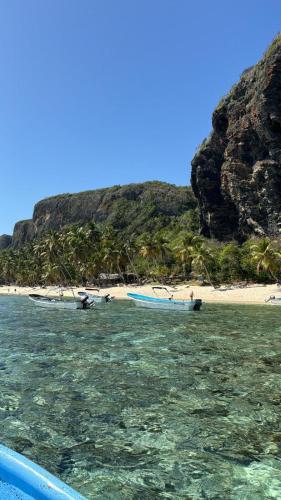 two boats in the water next to a beach at Villa KAMBUSA in Las Galeras