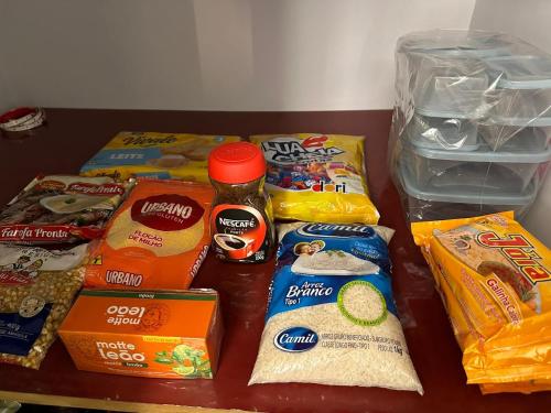 a table topped with different types of food at Kitnet em Americana SP in Americana