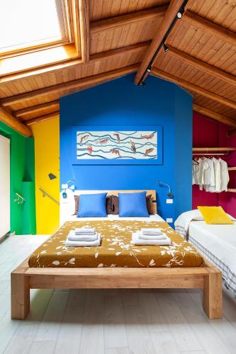a bedroom with a bed with a blue wall at Veruskacamere Camera Deluxe 2 in Somma Lombardo
