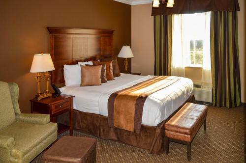 a hotel room with a bed and a chair at The Lodge at Flat Rock in Upward