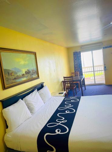 a hotel room with a bed with a sign on it at Sea Shell Inn on the Beach in Corpus Christi