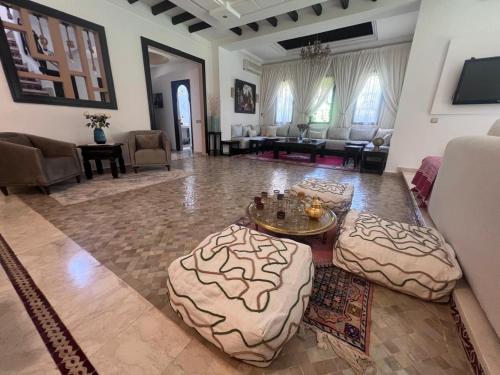 a living room with a couch and a table at Maison d'Hôte Angele in Sfiani