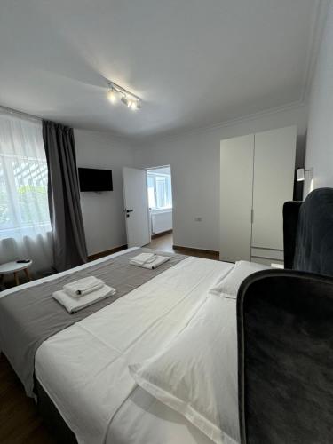 a bedroom with a large bed with two towels on it at Nord 22 in Constanţa