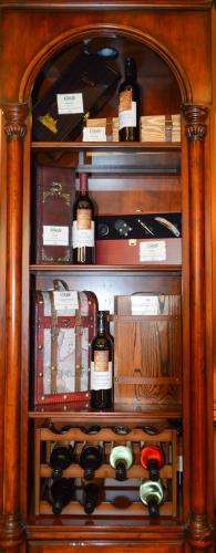a cabinet filled with lots of bottles of wine at The Lodge at Flat Rock in Upward