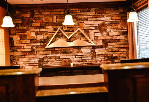 a brick wall with a bench in a restaurant at The Lodge at Flat Rock in Upward