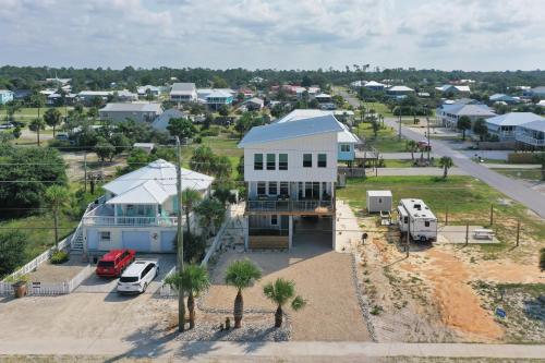an aerial view of a white house with a parking lot at Rejuvenation by Pristine Properties Vacation Rentals in Saint Joe Beach