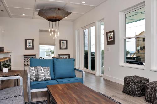 a living room with a blue couch and a table at Rejuvenation by Pristine Properties Vacation Rentals in Saint Joe Beach