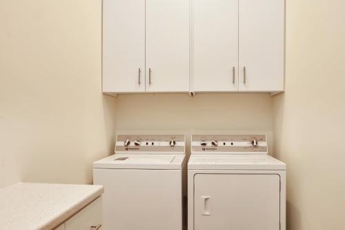 a kitchen with white cabinets and white appliances at Rejuvenation by Pristine Properties Vacation Rentals in Saint Joe Beach