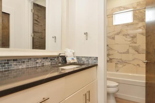 a bathroom with a sink and a toilet at Rejuvenation by Pristine Properties Vacation Rentals in Saint Joe Beach