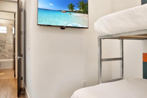 a bedroom with a flat screen tv on the wall at Rejuvenation by Pristine Properties Vacation Rentals in Saint Joe Beach