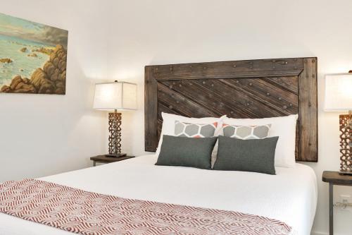 a bedroom with a large white bed with two lamps at Rejuvenation by Pristine Properties Vacation Rentals in Saint Joe Beach