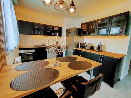 une cuisine avec une table en bois et une salle à manger dans l'établissement Le Royaume des Sens, à Sainte-Opportune-du-Bosc