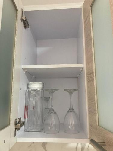 two glass wine glasses and a jar in a drawer at Apartahotel Poblado-Aguacatala in Envigado