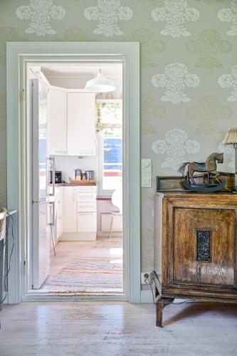 a kitchen with a door leading to a dining room at Wanha Rojola 