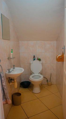 a bathroom with a toilet and a sink at Coastal Beach Bliss in Langstrand