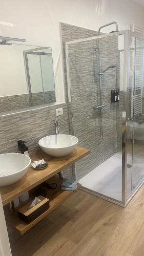 a bathroom with two sinks and a shower at RG MAISON - Suite 29 in Morino