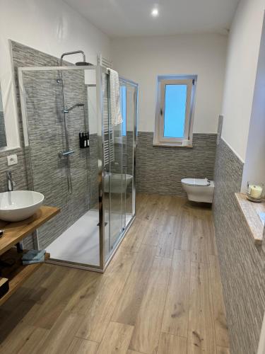 a bathroom with a glass shower and a sink at RG MAISON - Suite 29 in Morino