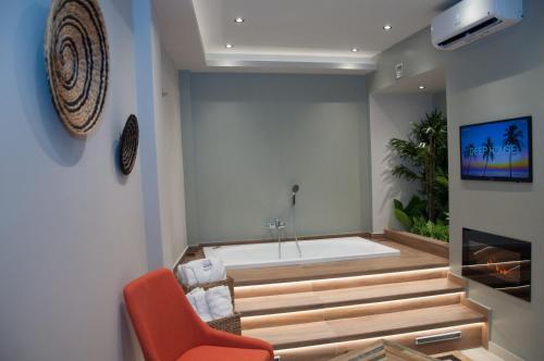 a bathroom with a bathtub and a chair and a tub at Secret Heaven JK in Ioannina