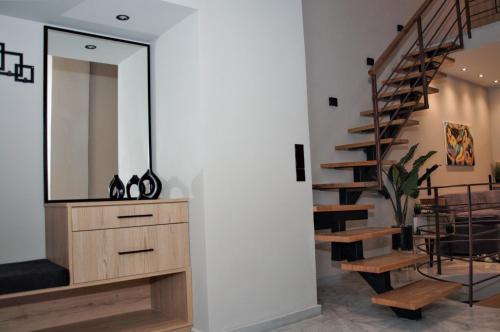 a mirror on a wall next to a staircase at Secret Heaven JK in Ioannina