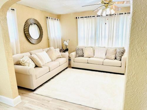 a living room with two couches and a mirror at Nest of beauty in Niagara Falls in Niagara Falls