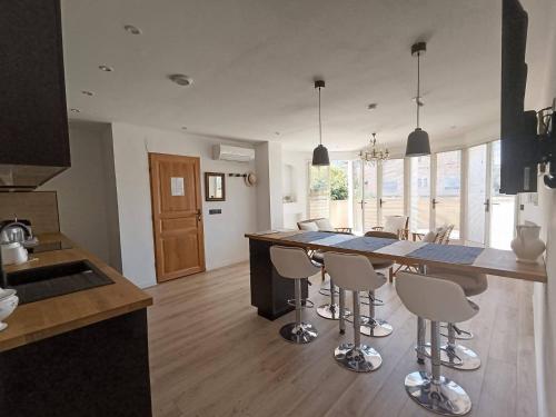 une cuisine avec un grand îlot et des tabourets de bar dans l'établissement Appartement 3 chambres avec terrasse vue mer à 150 m de la plage, à Marseille