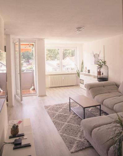 a living room with a couch and a table at AllgäuBrise in Sonthofen