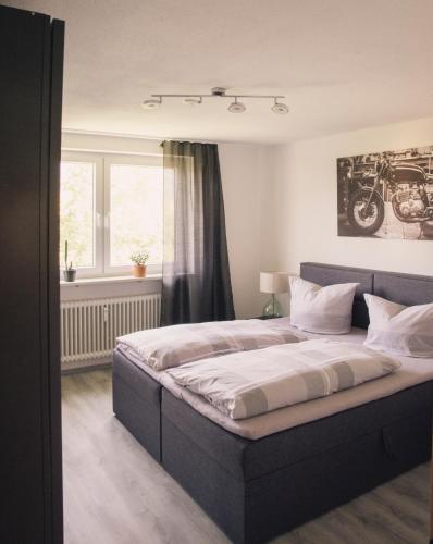 a bedroom with a large bed in front of a window at AllgäuBrise in Sonthofen