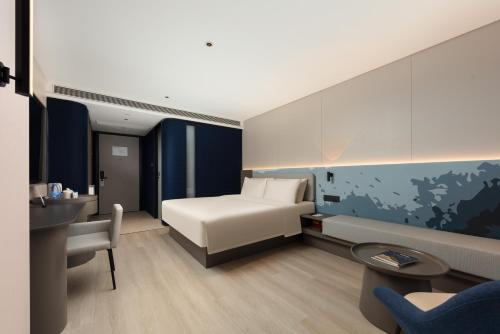 Postel nebo postele na pokoji v ubytování Atour Light Hotel Haikou Guomao Wanlv Garden