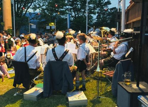 a group of people in uniform playing music in front of a crowd at Weil ich es mir wert bin in Seehausen am Staffelsee