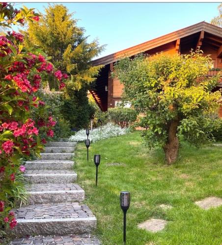 a garden with a stone path and flowers and a house at Weil ich es mir wert bin in Seehausen am Staffelsee