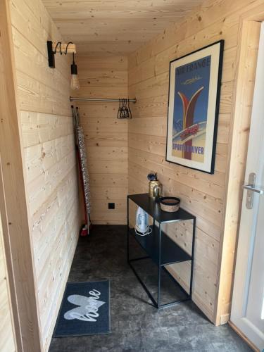 Cette chambre est dotée d'une petite table dans un mur en bois. dans l'établissement Chalet Pagotin - Le Renversant, à Métabief