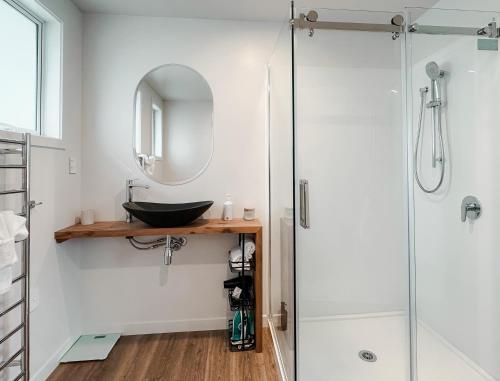 a bathroom with a sink and a shower at Two One Two in Hokitika