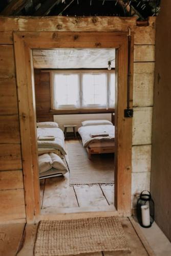 a room with a room with several beds in it at Familien-Chalet am Alpstein für Gruppen bis 12 Personen und Familien, Appenzell Premium Privatunterkunft im Ski- und Wandergebiet Hoher Kasten in Brülisau