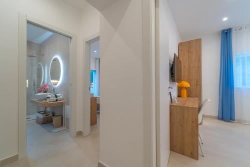 a white bathroom with a sink and a mirror at Villa Vittorio in San Teodoro