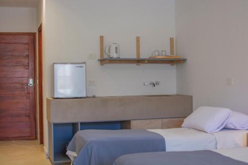 a hospital room with two beds and a sink at Hotel Cerros del Norte in Tilcara