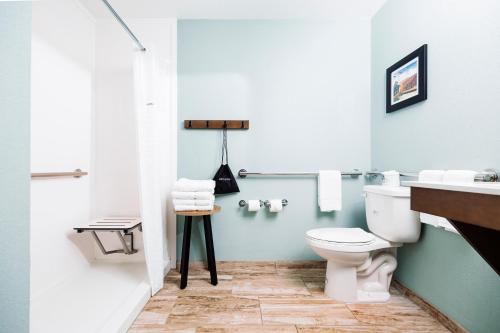 a bathroom with a toilet and a sink at The Windstar Hotel - Carolina Beach in Carolina Beach