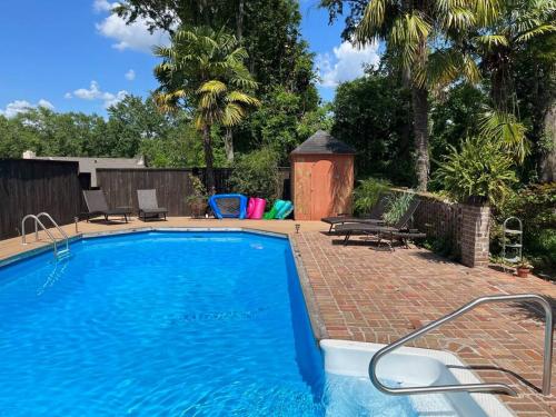 a swimming pool with a brick walkway next to a brick at Jenny's Cottage WPool 3 Blocks from Downtown in Laurel