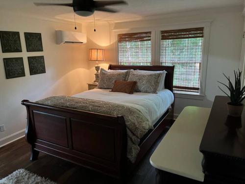 a bedroom with a bed and a ceiling fan at Jenny's Cottage WPool 3 Blocks from Downtown in Laurel