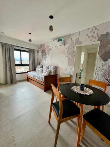 a bedroom with a bed and a table and chairs at Augusto Apart 4 in Salta