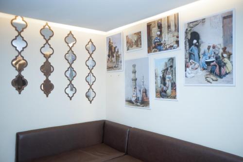 a room with a couch and pictures on the wall at New Comfort Inn Giza in Cairo