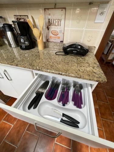 a drawer in a kitchen with utensils in it at Caribean Praia das Toninhas - A 100 metros da areia 21A in Ubatuba
